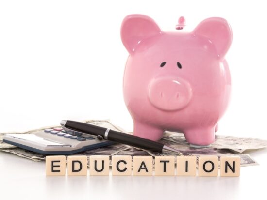 529 savings Piggy bank beside calculator savings for college